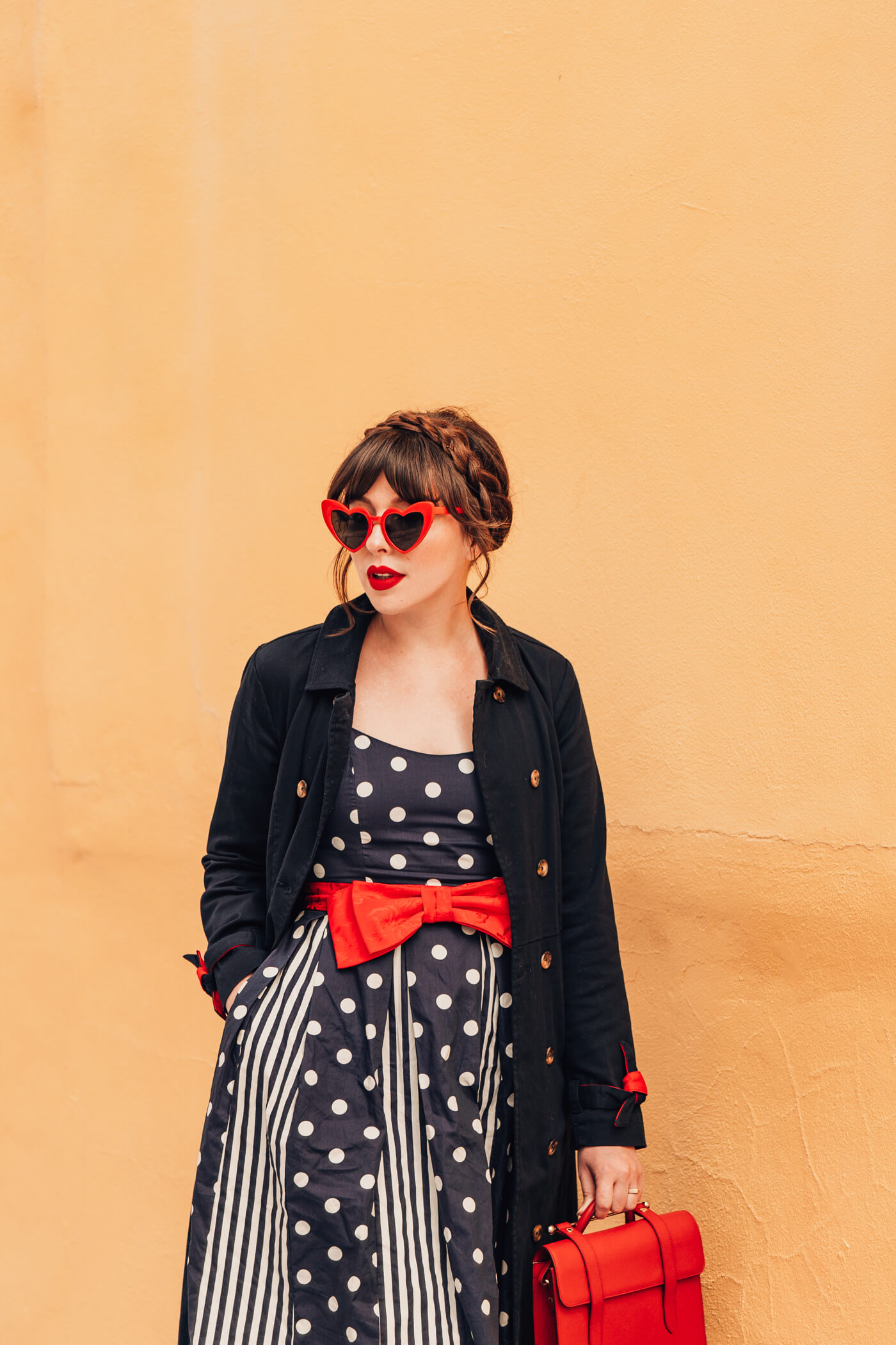 woman in polka dot dress and black jacket for against the current