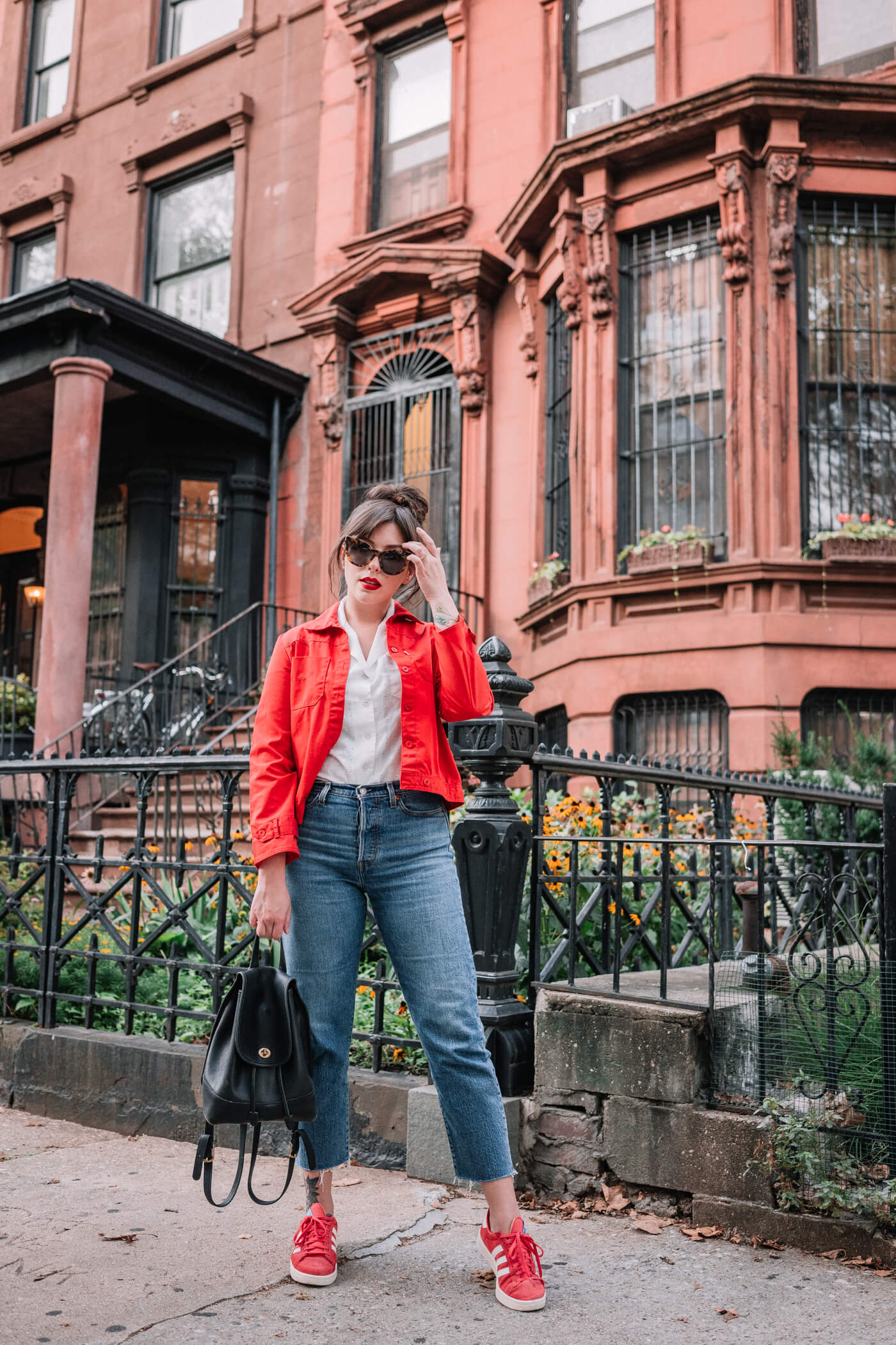 woman wearing One Shirt 30 Ways, red jacket, and denim jeans