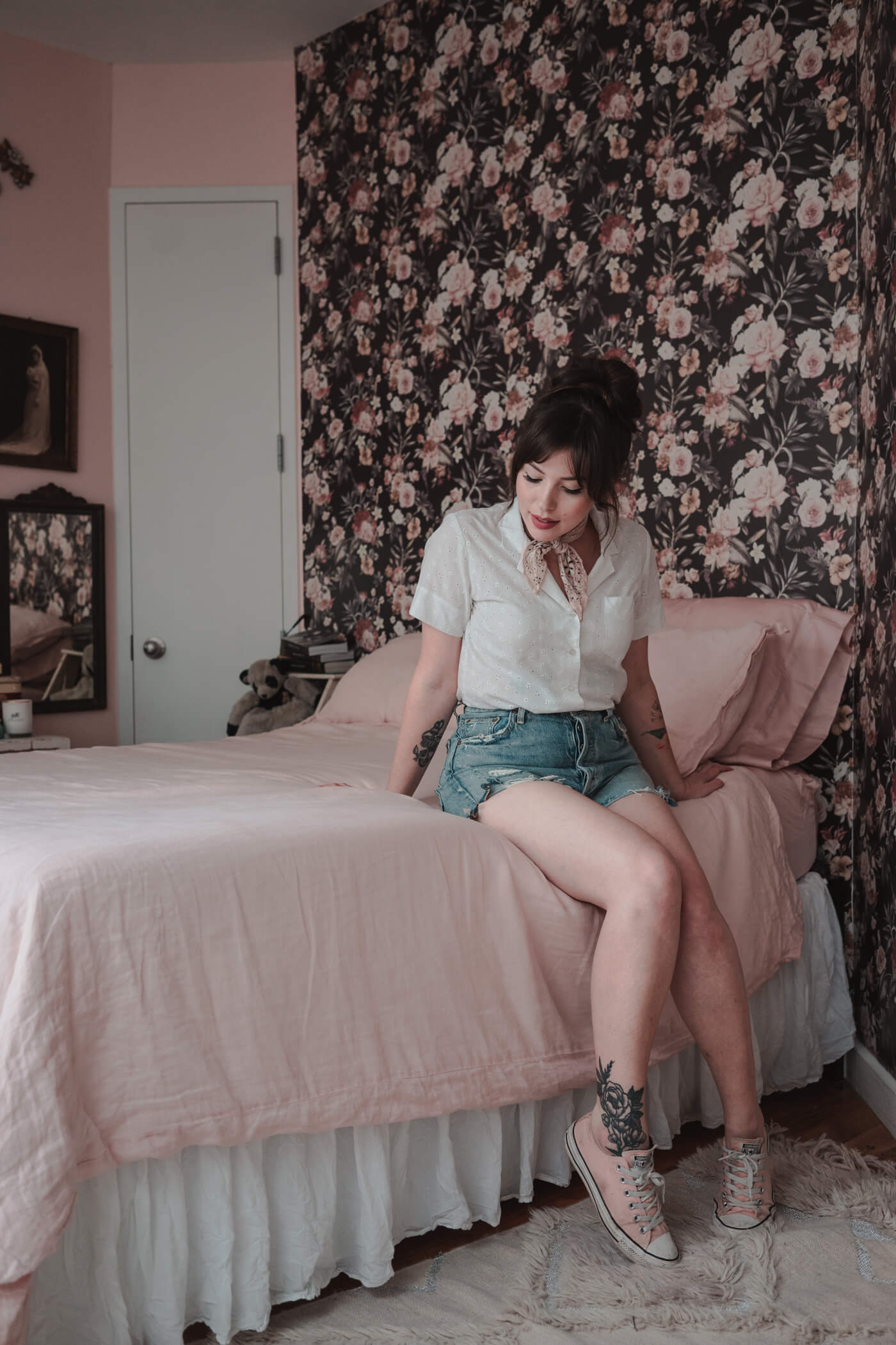 woman sitting on her bed