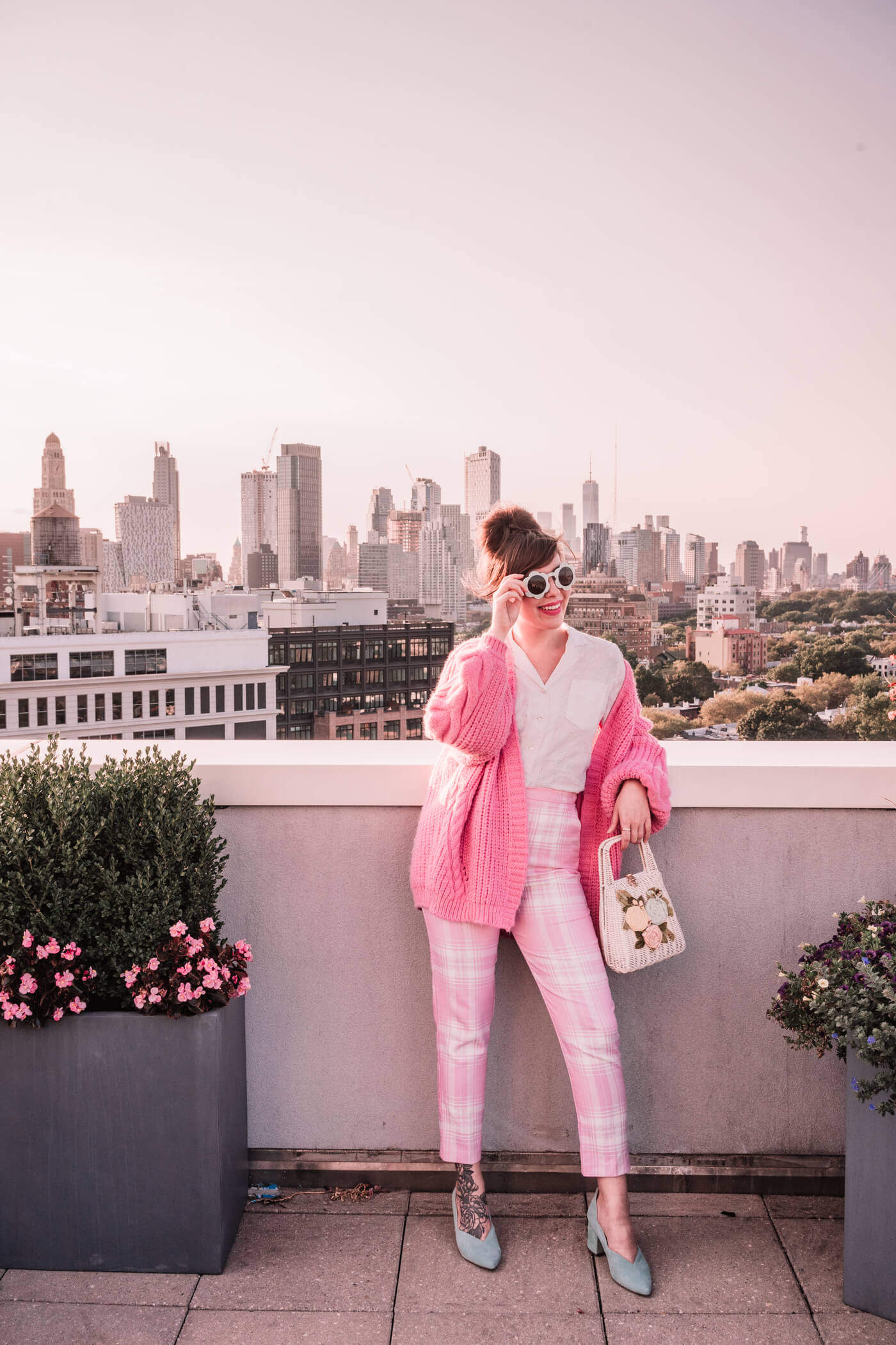 woman wearing white top and pink pants and sweater