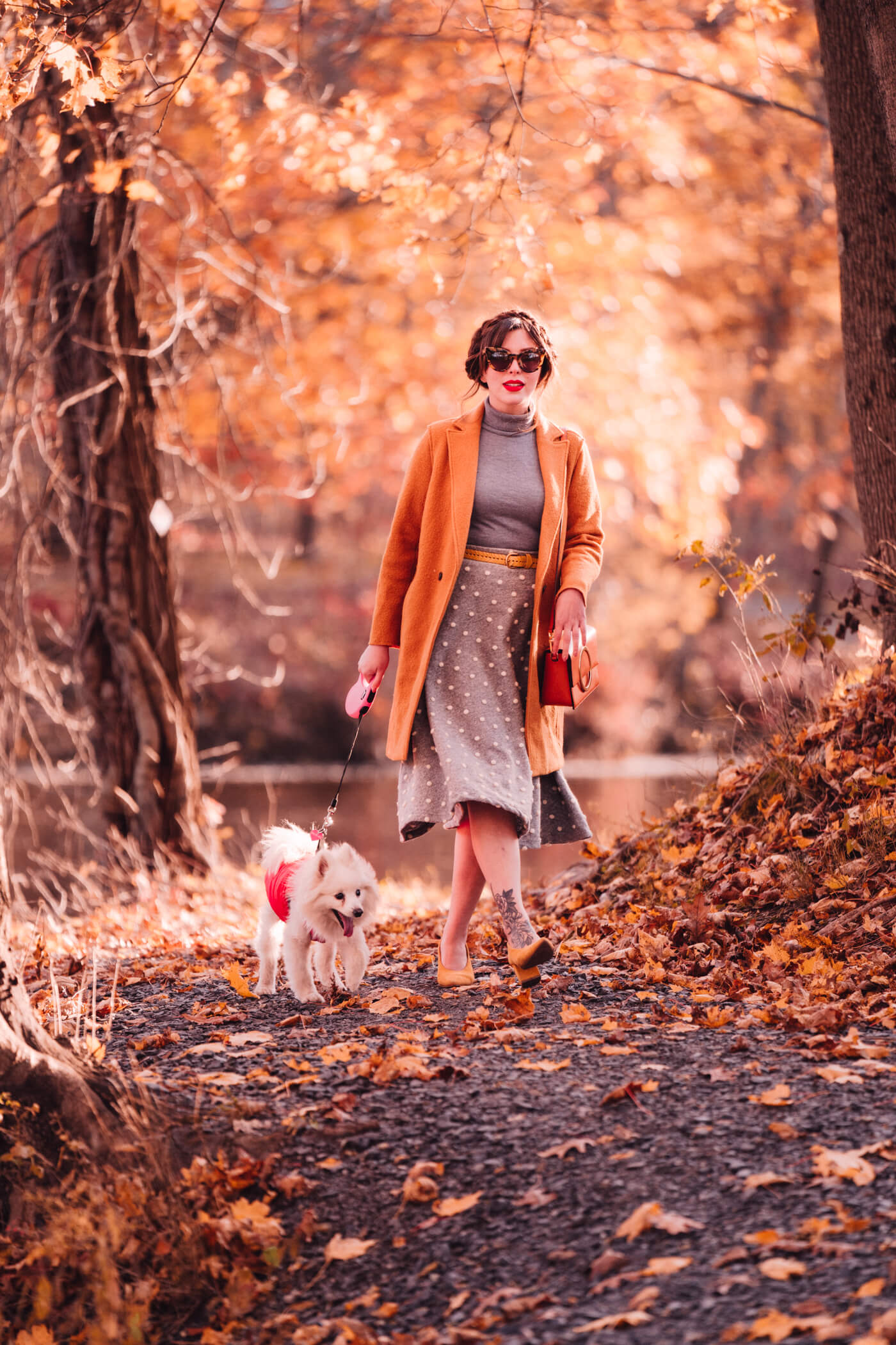 woman walking her dog for Fall Outfit Roundup