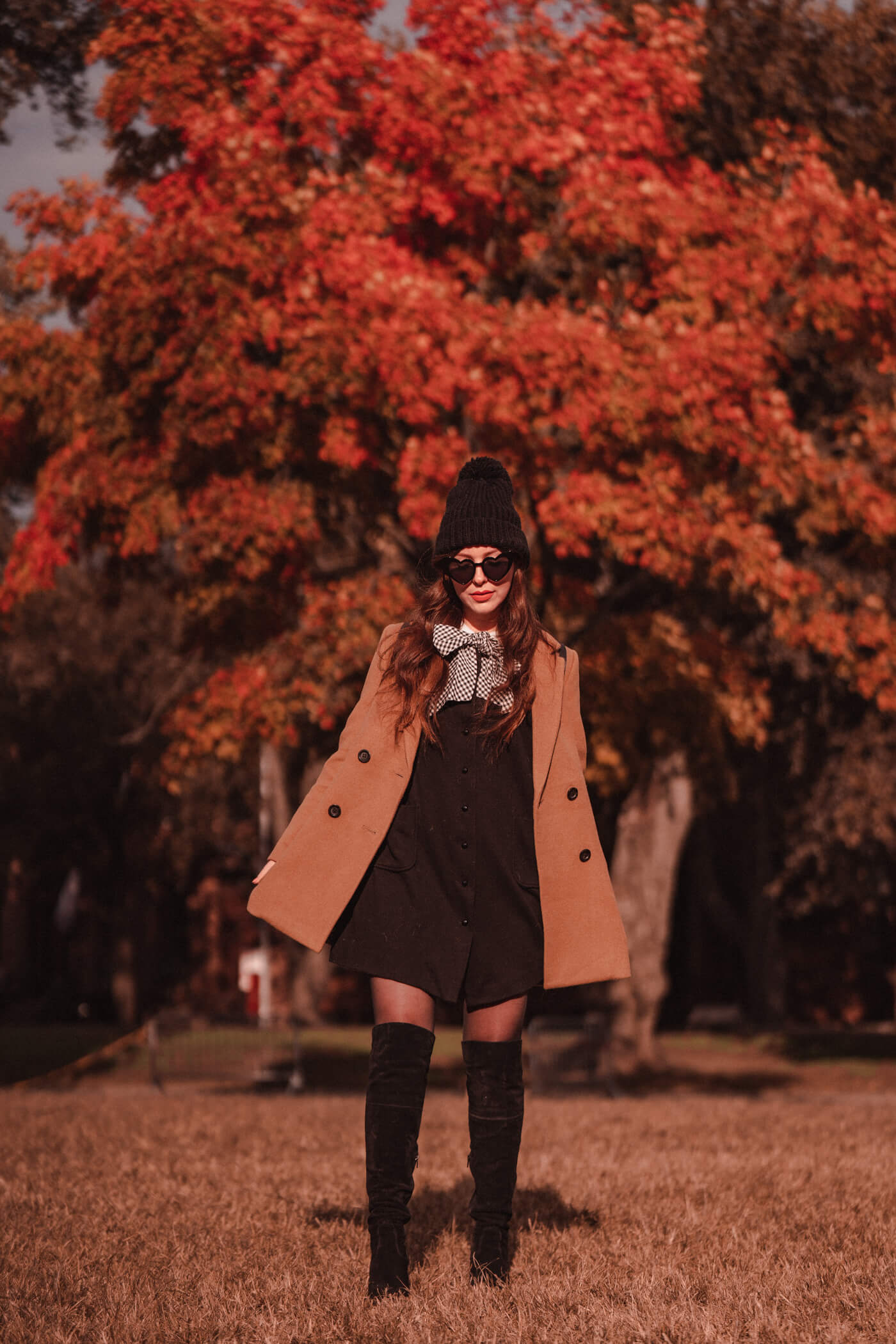 woman wearing black boots, dress, and coat for Fall Outfit Roundup