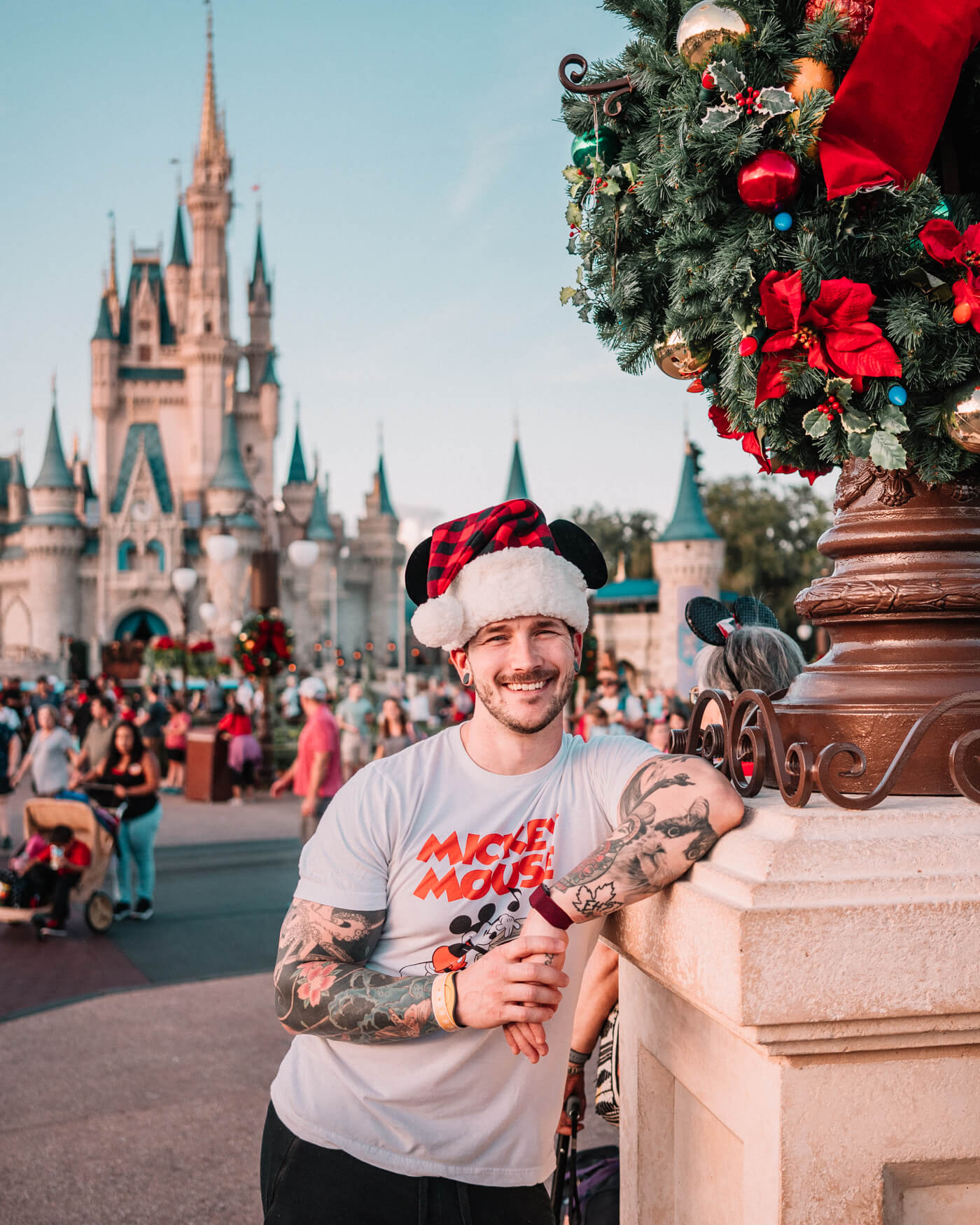 guy wearing a santa mickey hat