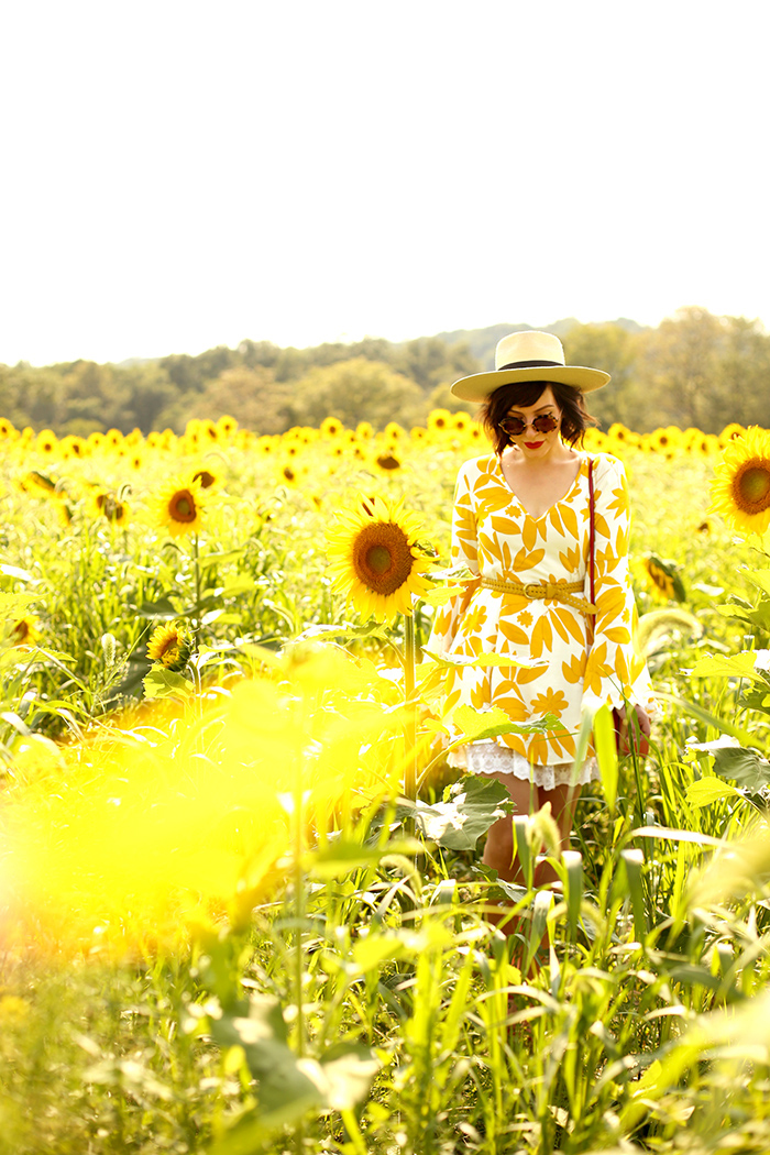 woman wearing asos sunflower dress