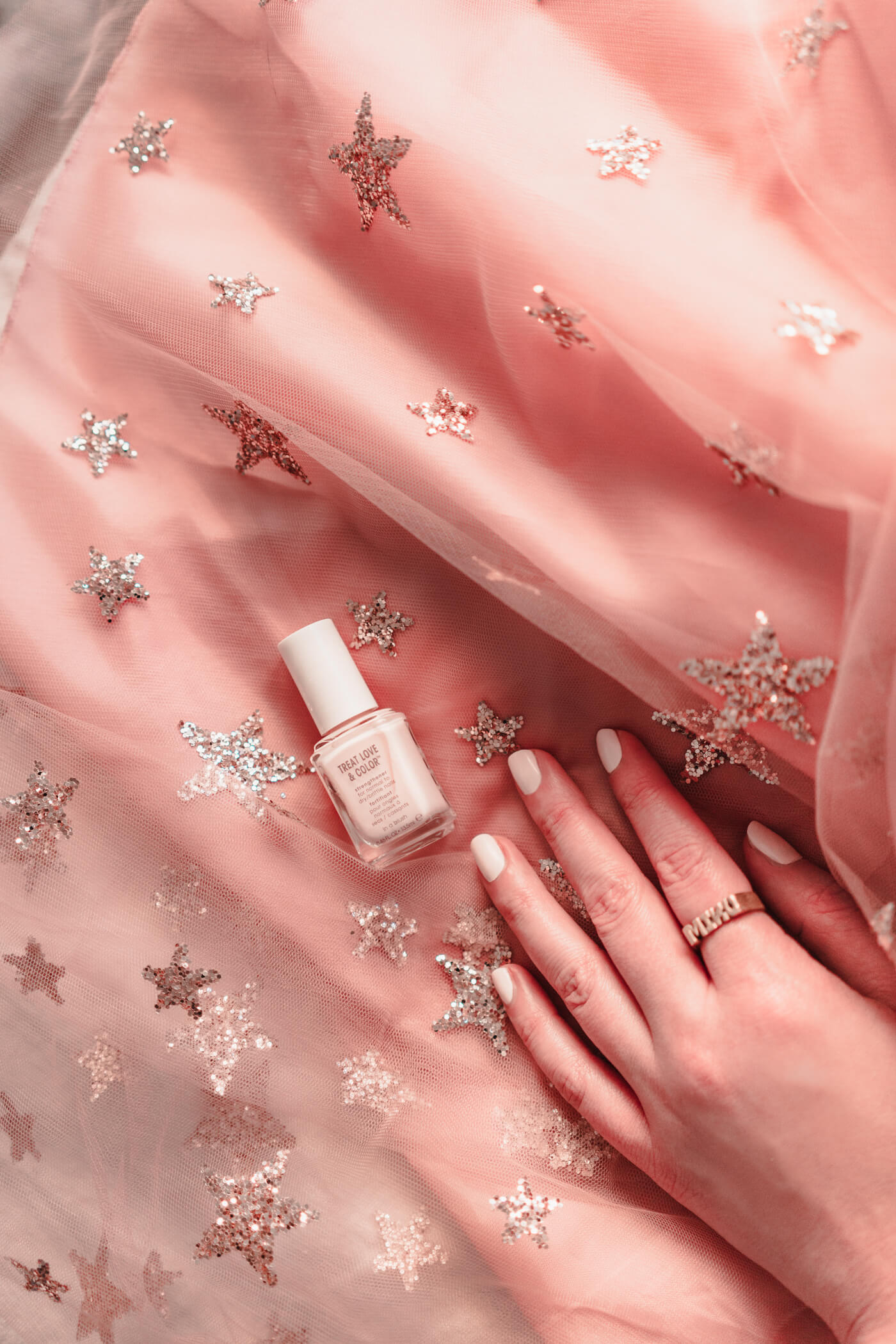 woman wearing essie treat love color "in a blush" and blush skirt 