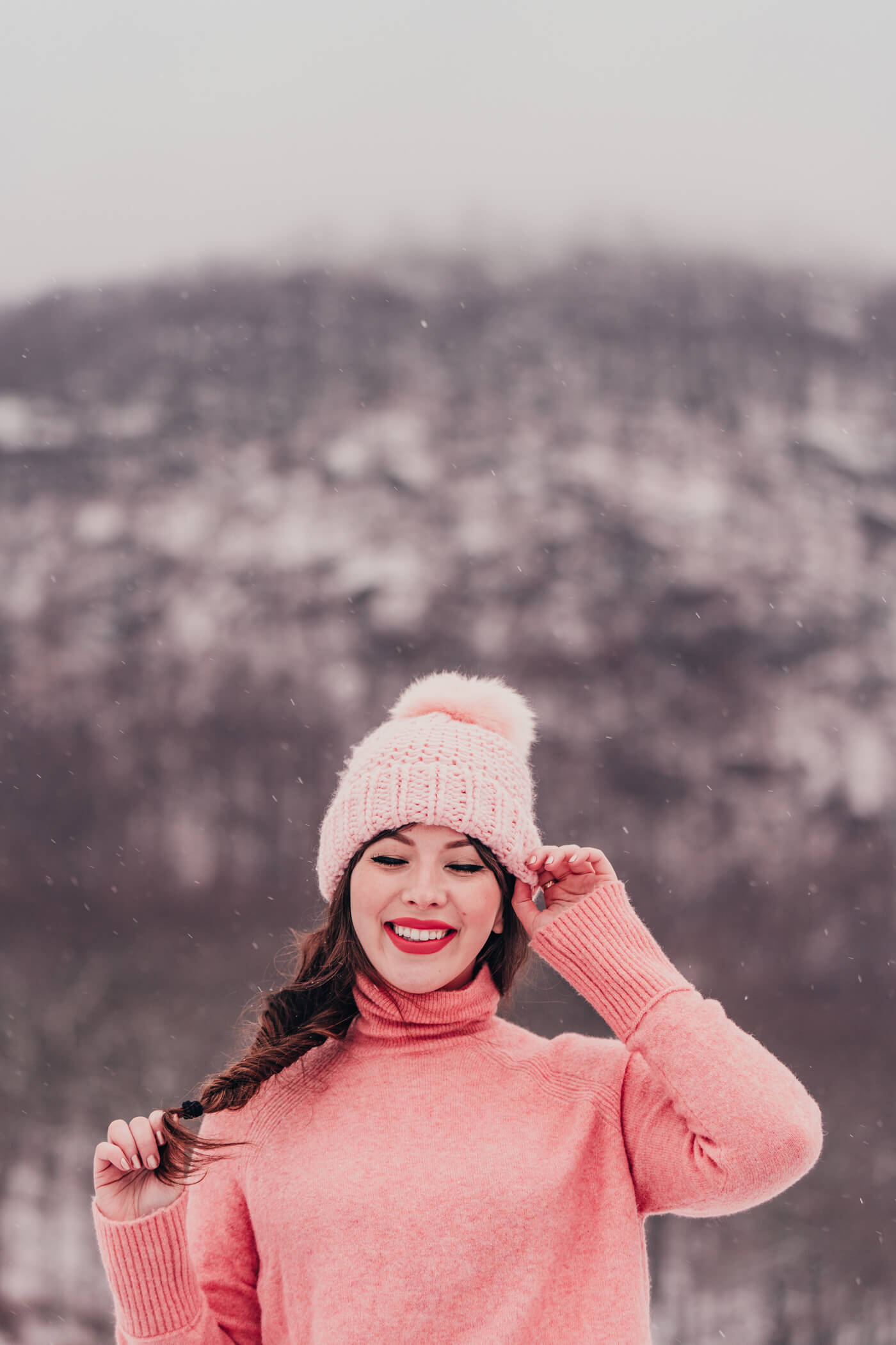 woman wearing Pink Winter Outfit under the snow 