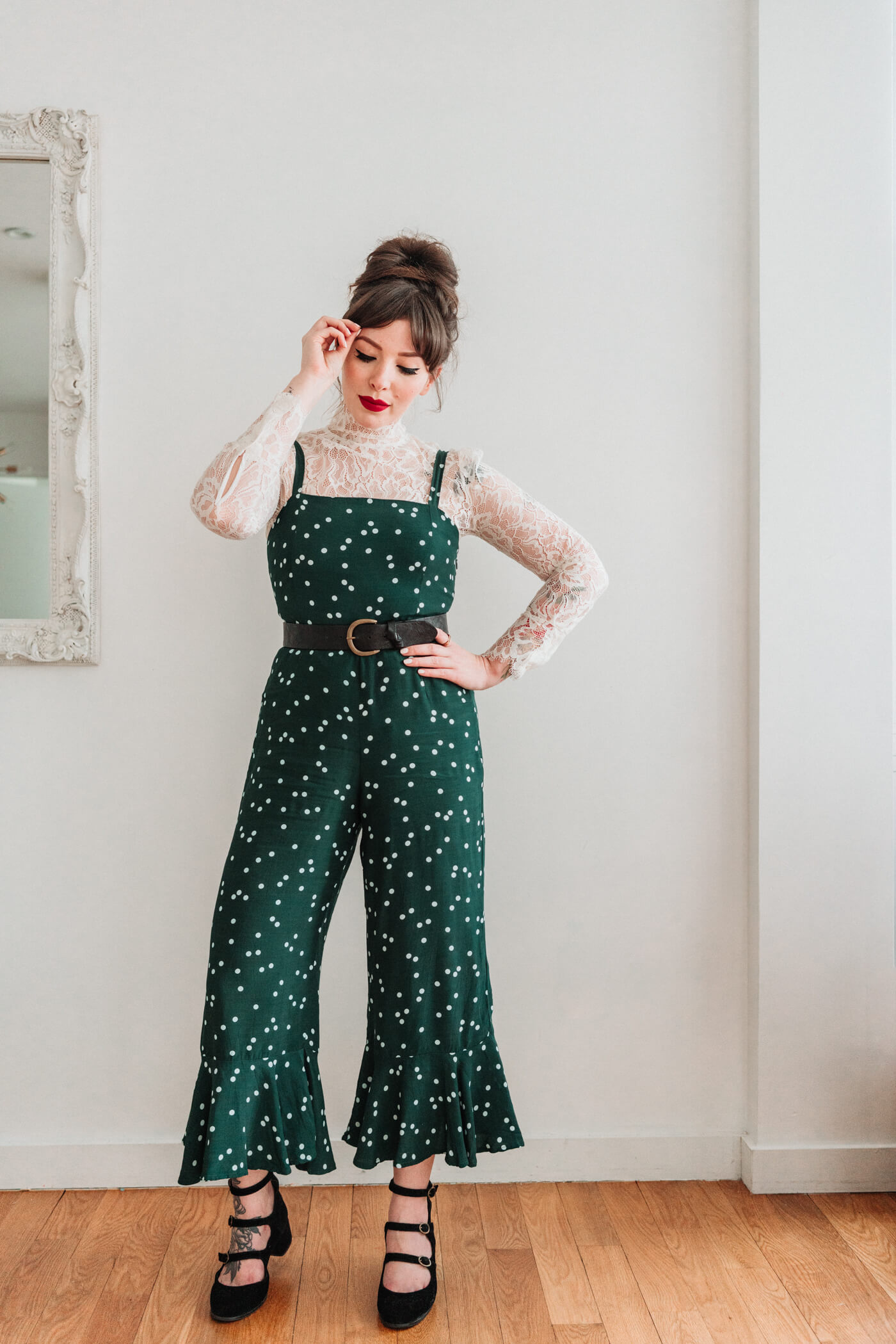 woman with polka dot jumpsuit and lace long sleeves 