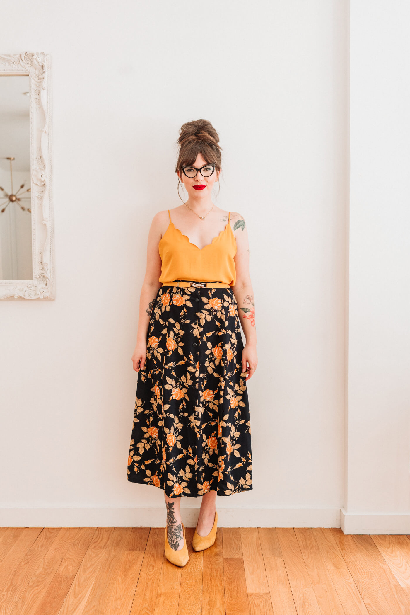 woman in yellow top and printed skirt 