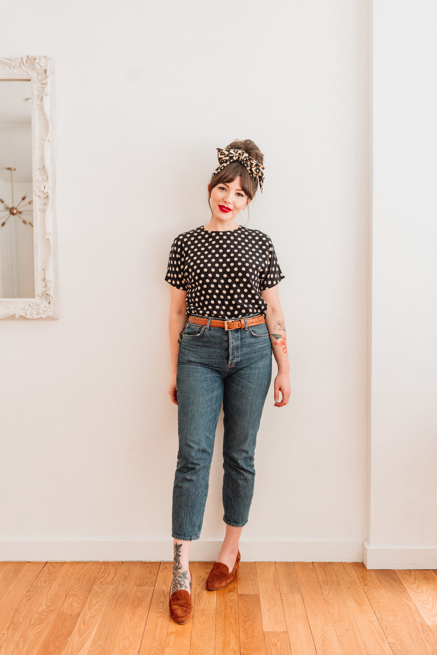 woman wearing polka dot top and jeans 