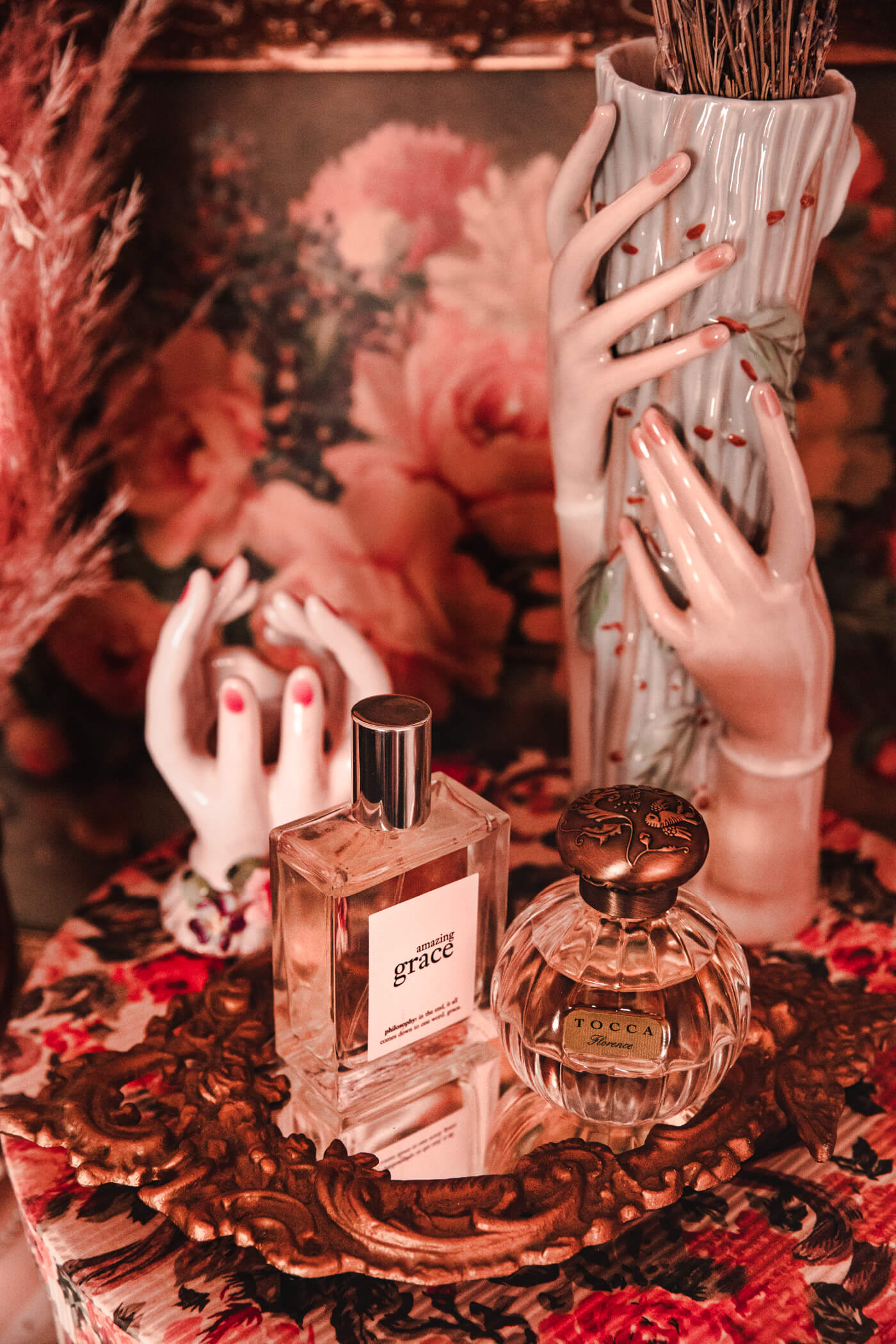 amazing grace perfume by philosophy on a table with hand figurines is one of the all time favorite perfumes of keiko