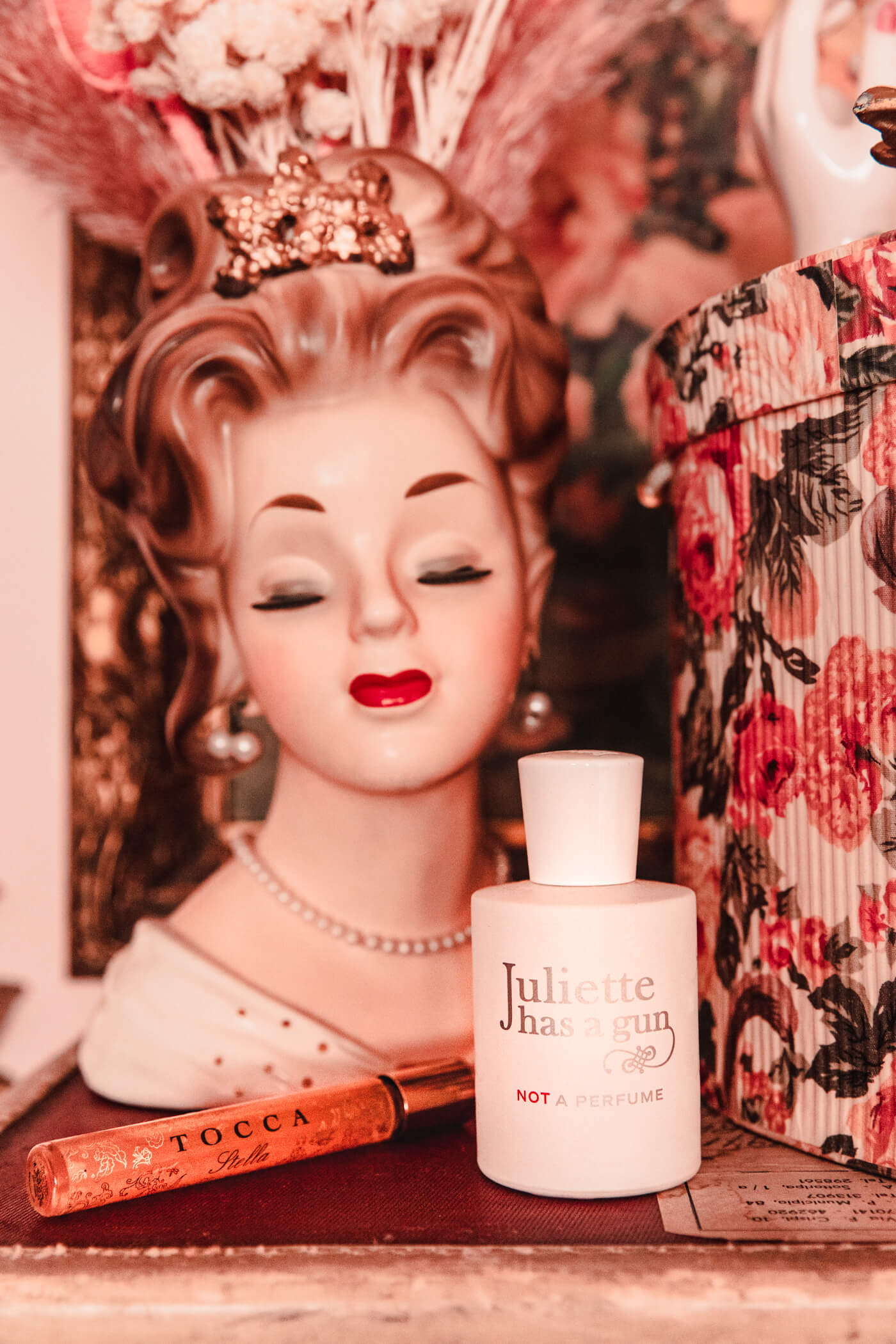 TOCCA Florence styled with figurine head, and floral box on a table is one keiko lynn's all time favorite perfume