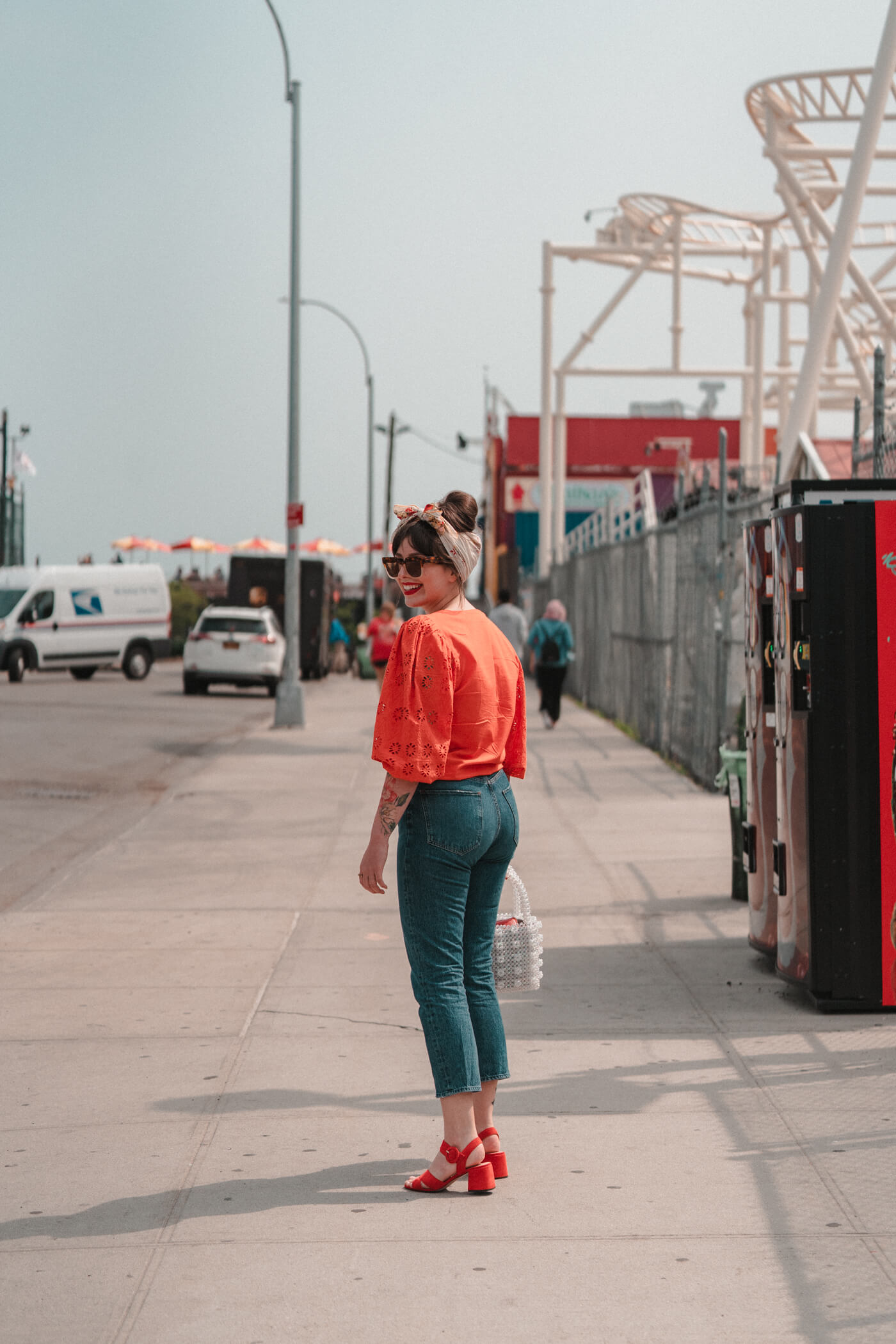 woman wearing AGOLDE "Riley" High Rise Jeans and orange top