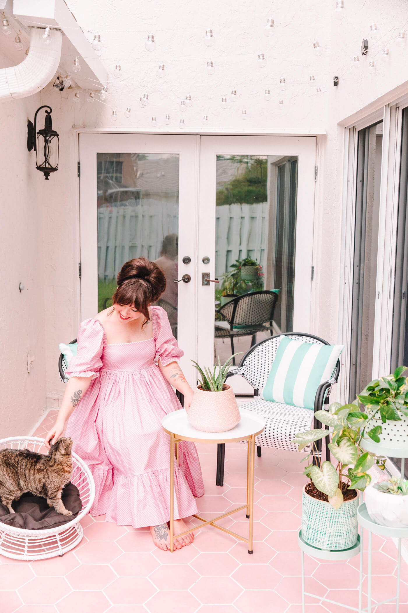 woman with her cat in the pastel patio