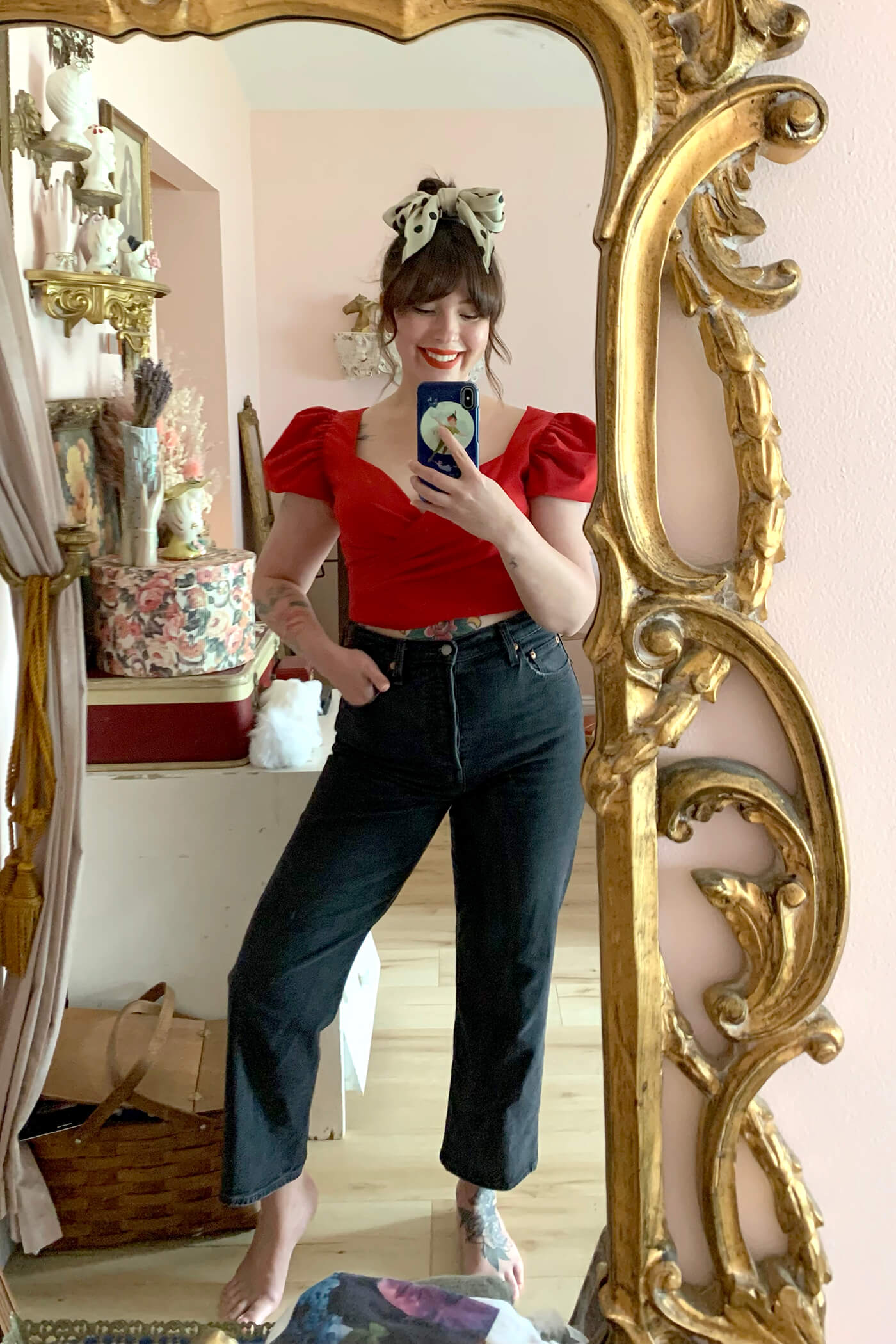 woman wearing red top and one of her favorite brands and styles of jeans from Levi's