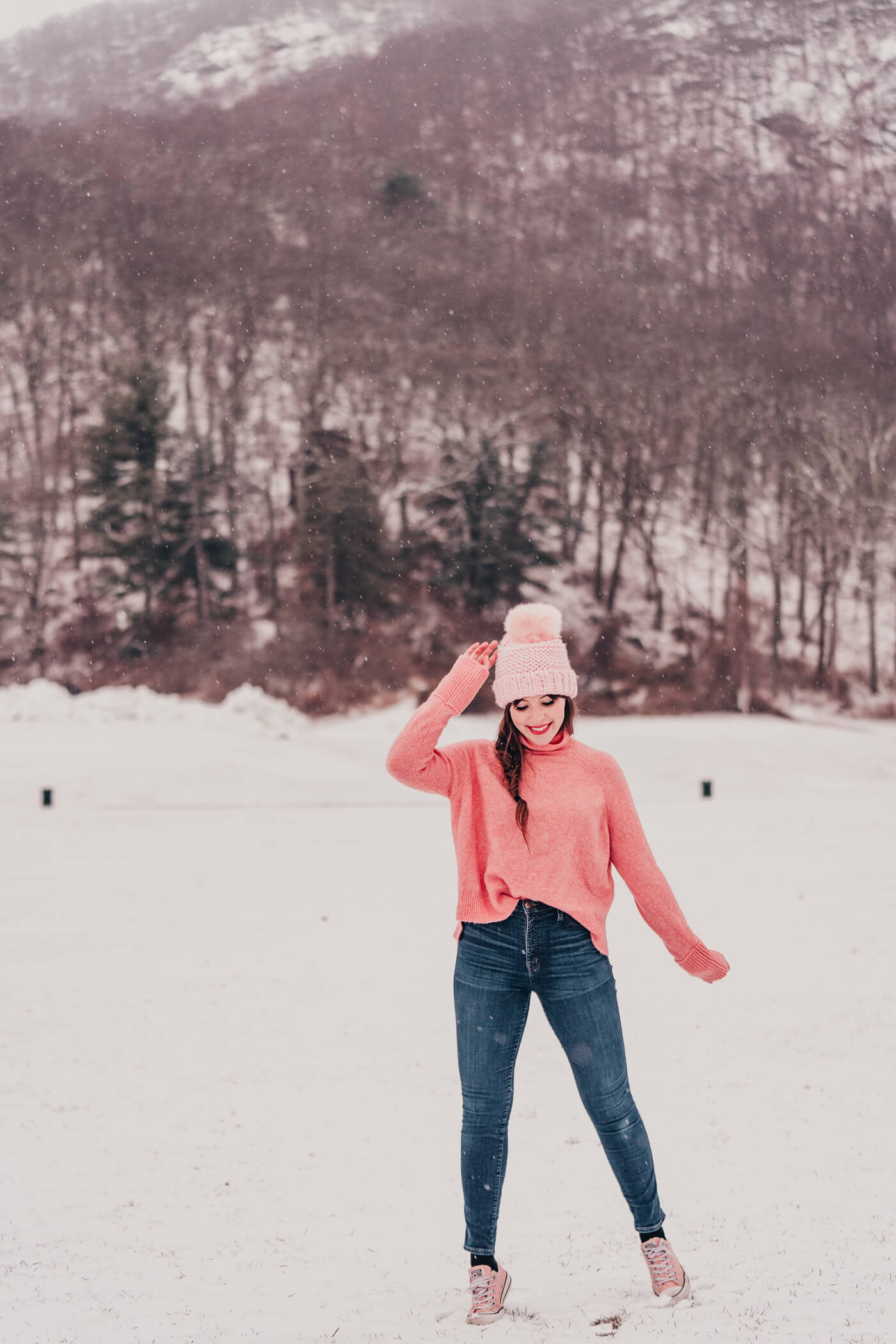 woman in the snow and wearing one of her favorite brands and styles of jeans