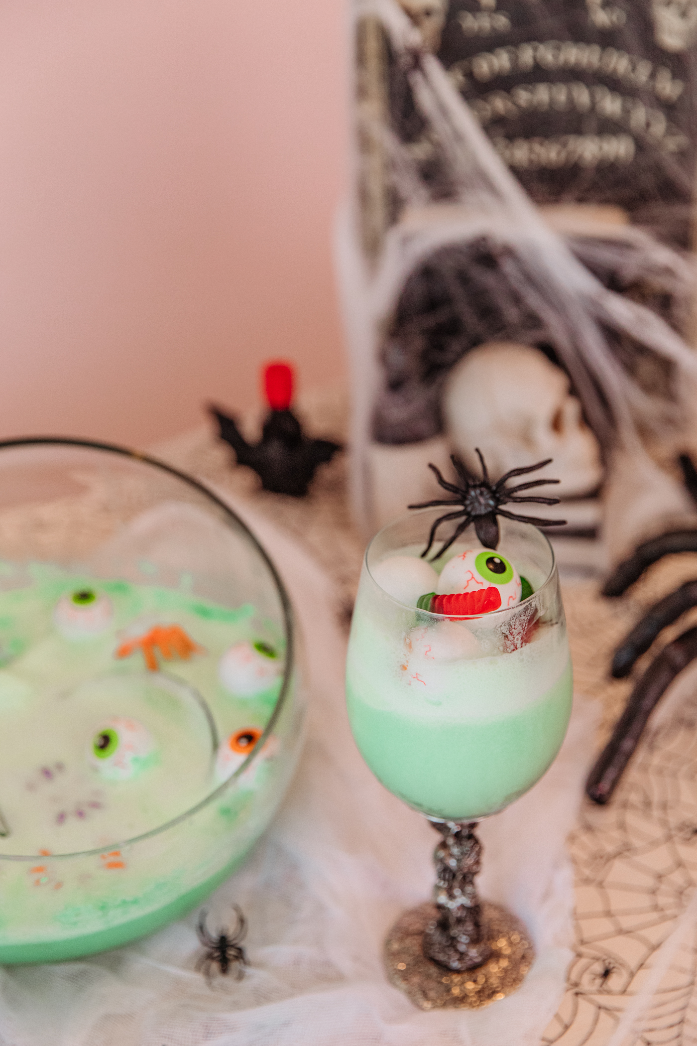 Halloween drink in a glass with candies and fake eye balls 