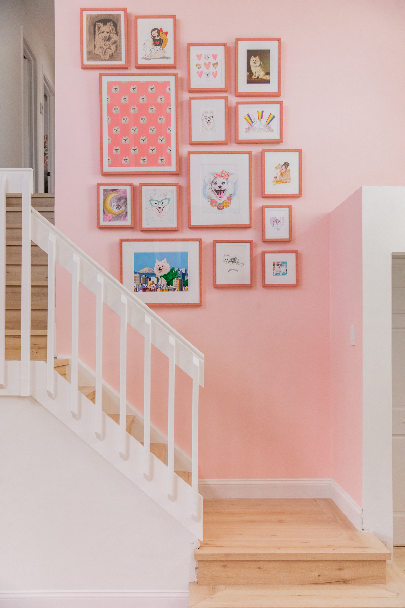 pink wall with Gallery Wall with Framebridge near the stairs 