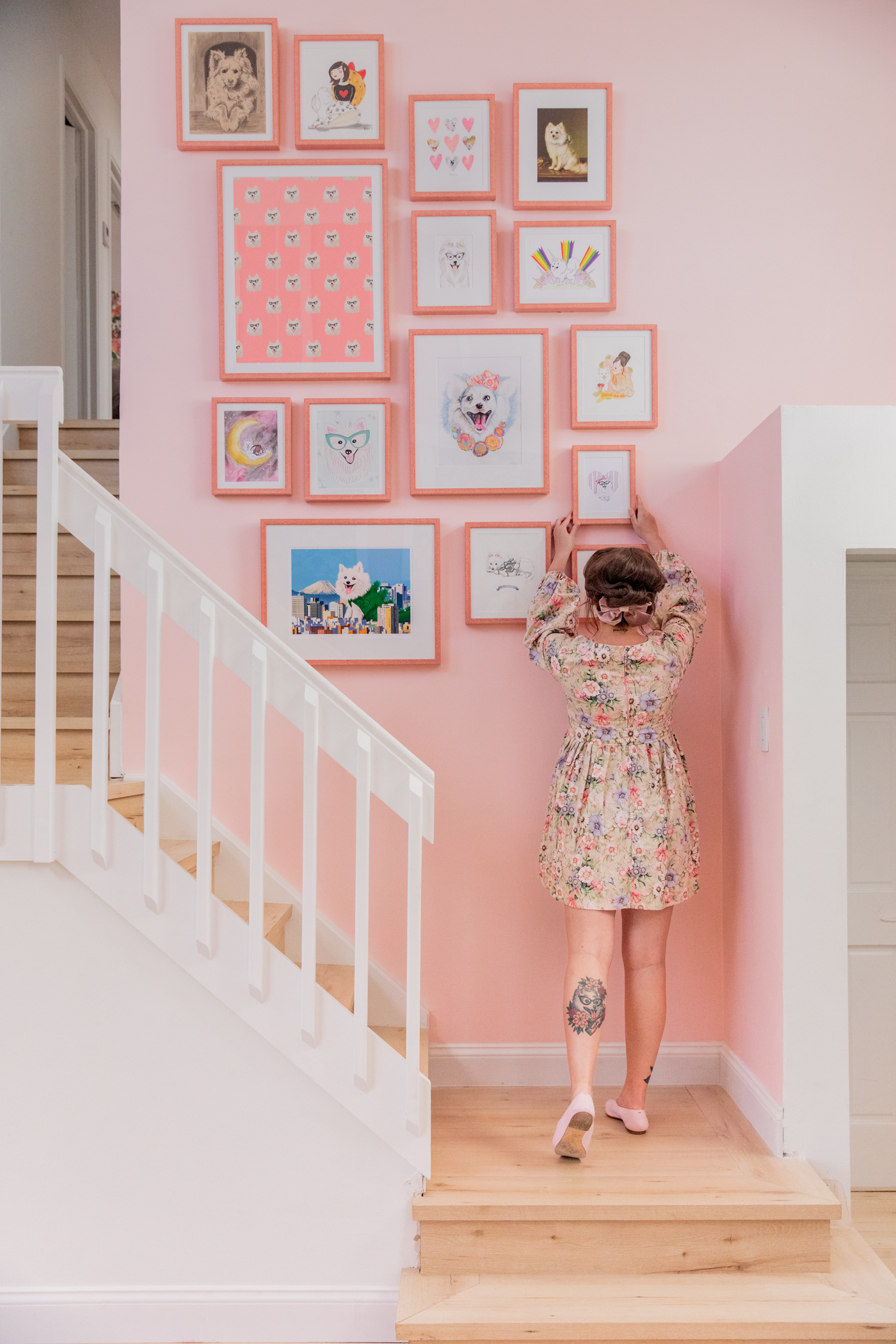 woman arranging her Gallery Wall with Framebridge