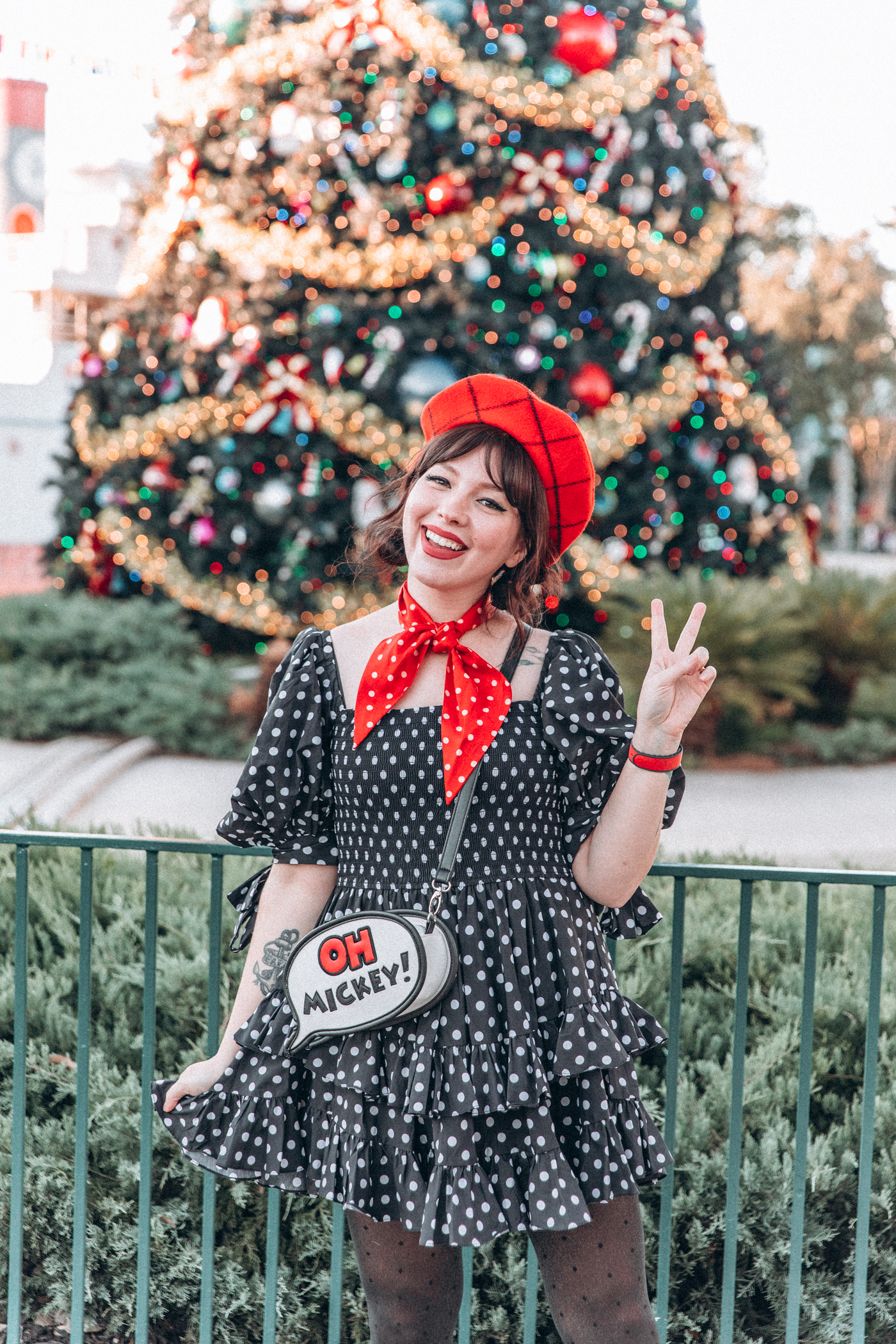 woman in polka dots dress with Oh Mickey bag