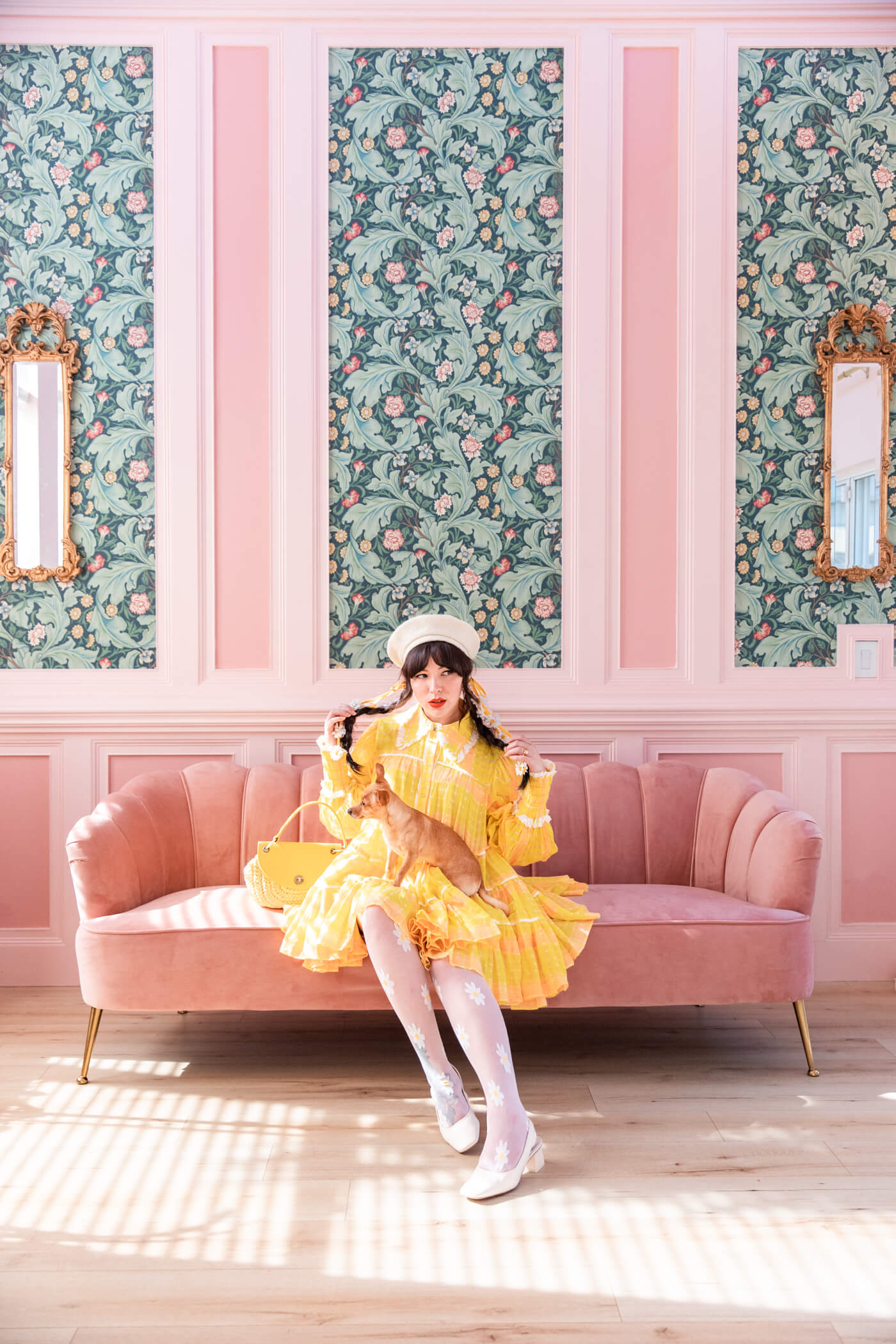 woman wearing perfect yellow dress and sitting on a pink chair 