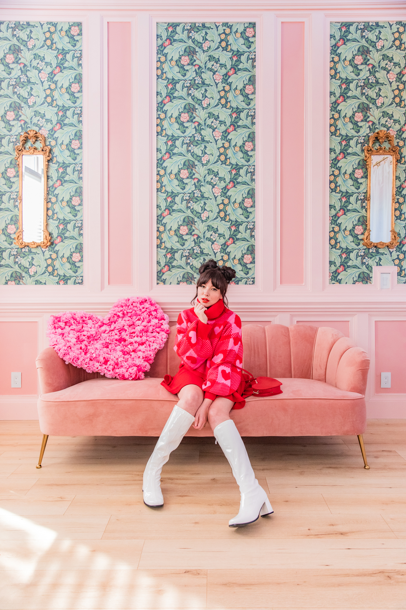woman sitting in pink couch and sharing her personal style