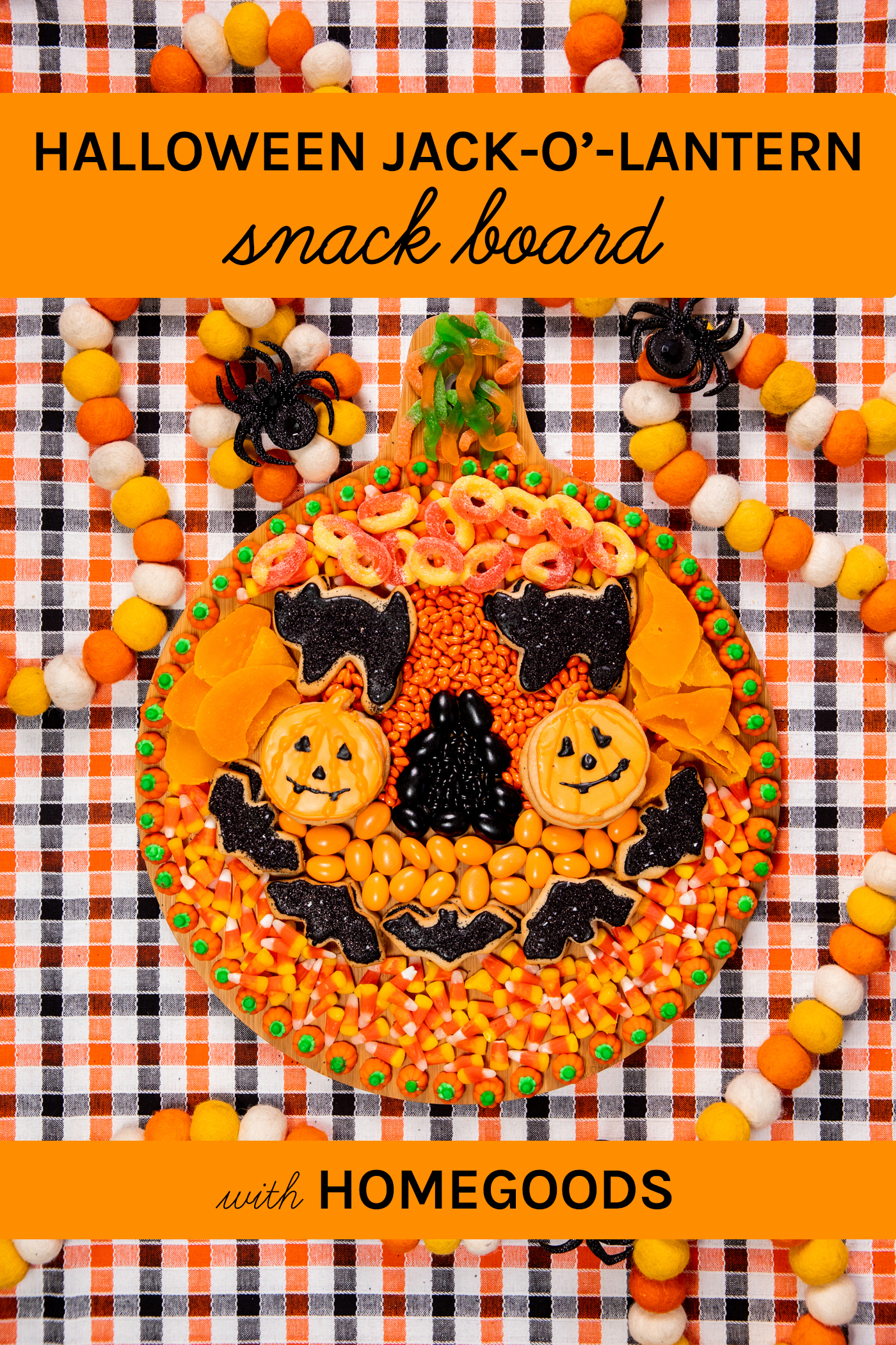 wooden halloween snack board with assorted orange and black snacks assembled to resemble a pumpkin